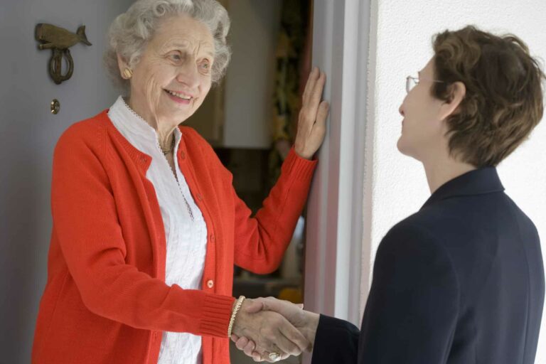 Senior woman at front door