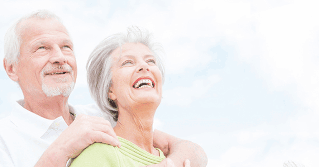 ELDERLY COUPLE LOOKING AT THE SKY SMILING