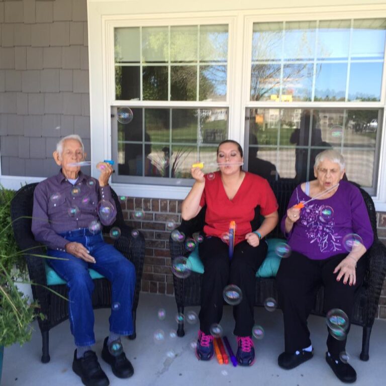 Residents blowing bubbles for memory care in monticello